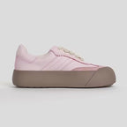 Pink sneaker with a brown sole on a light gray background