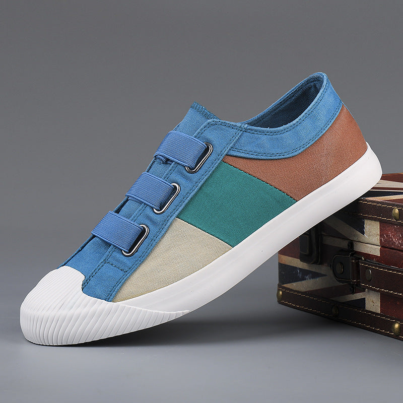 Multicolored sneaker with blue, brown, and green sections on a gray background