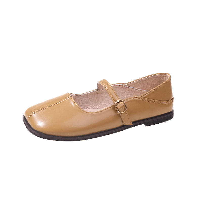 Tan shoe with a strap on a white background