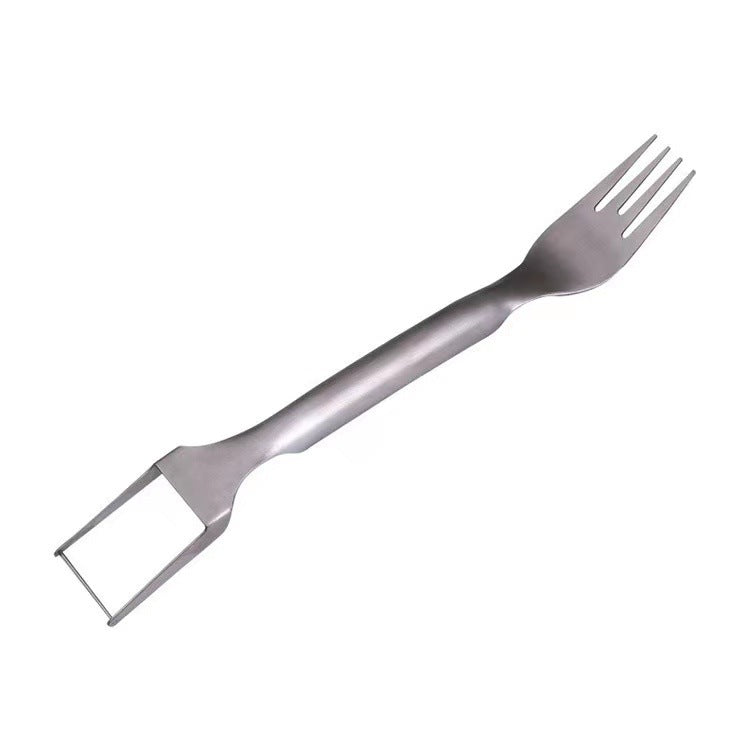 Metallic fork with a scraper attachment on a white background