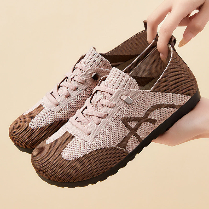 Pair of brown and beige sneakers on a beige background