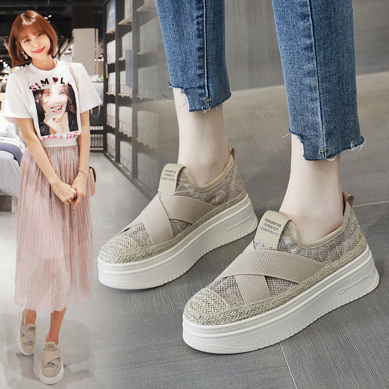 Beige platform sneakers worn by a person, with a blurred background of a woman in a store.
