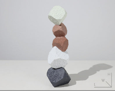 Stack of multicolored concrete blocks on a white background