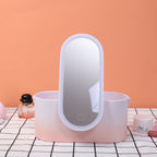 Pink vanity mirror with light on a checkered tablecloth against an orange wall