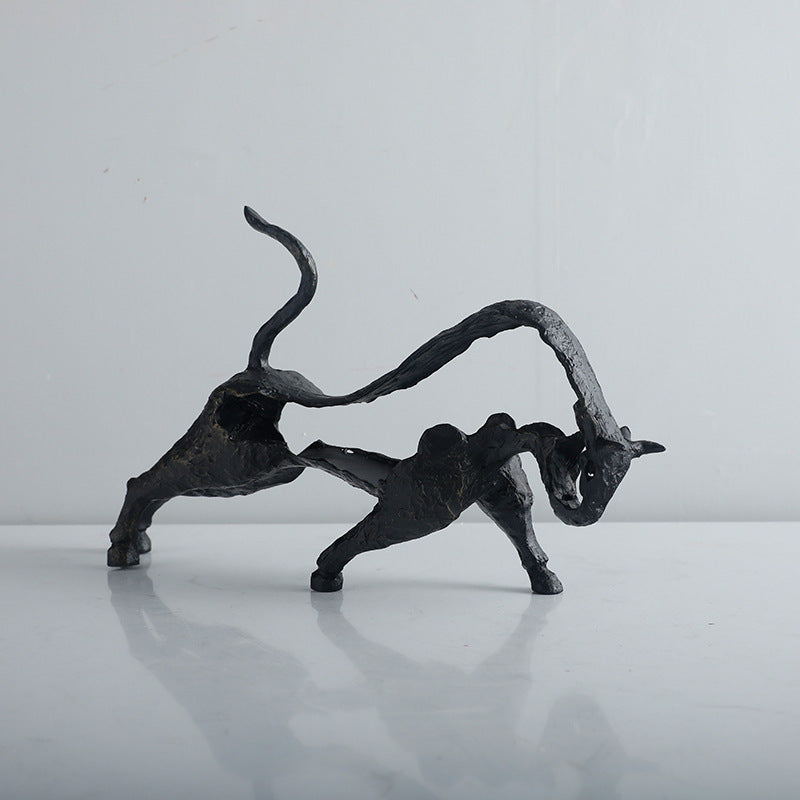 Two black metal animal sculptures on a white background