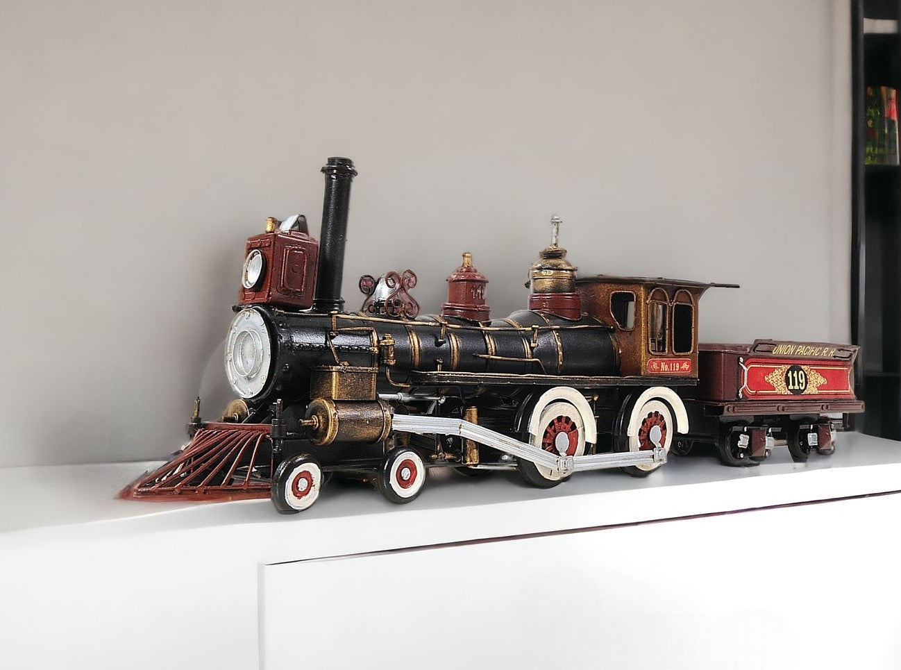 Model steam locomotive on a white surface with a neutral background