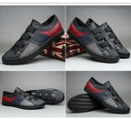 Black and red sneakers with velcro straps on a gray background