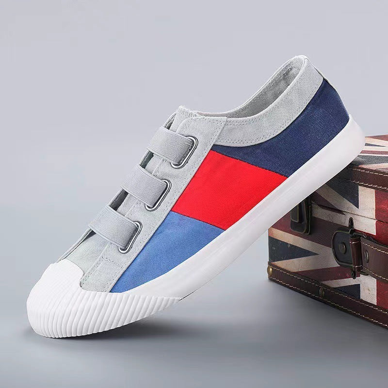 Colorful sneaker with gray, red, and blue design on a gray background
