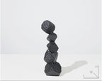 Stack of black rocks on a white background