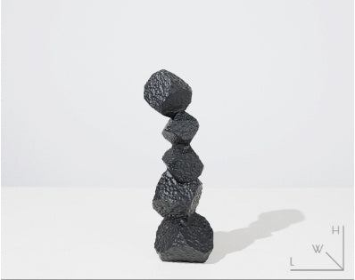 Stack of black rocks on a white background