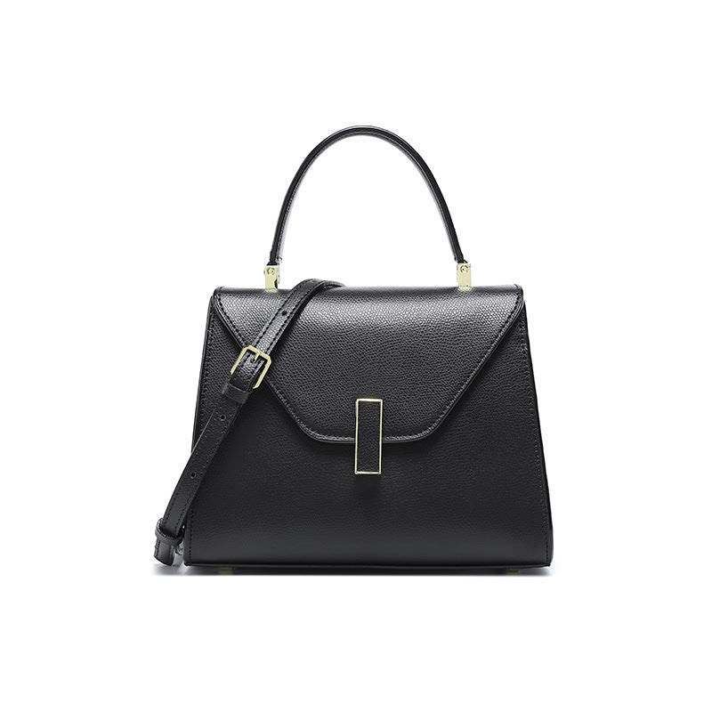 Black handbag with gold accents on a white background