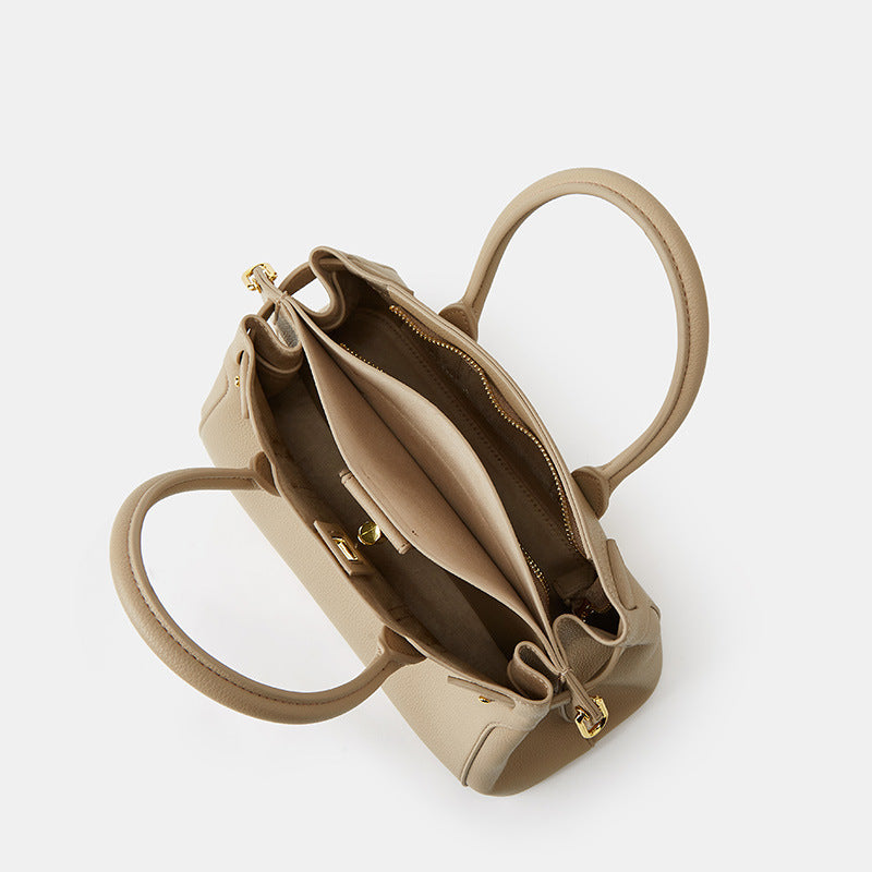 Beige handbag with open top on a white background