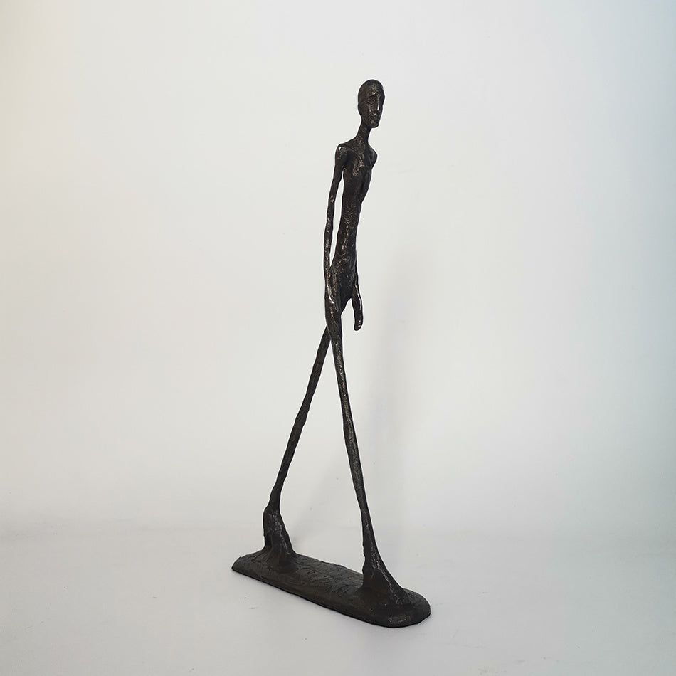 Abstract sculpture of a humanoid figure on a white background