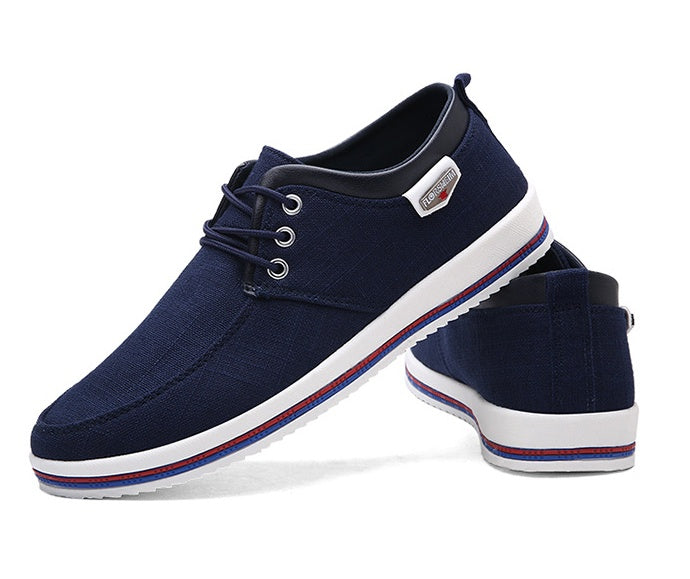 Navy blue casual shoe with white sole on a white background