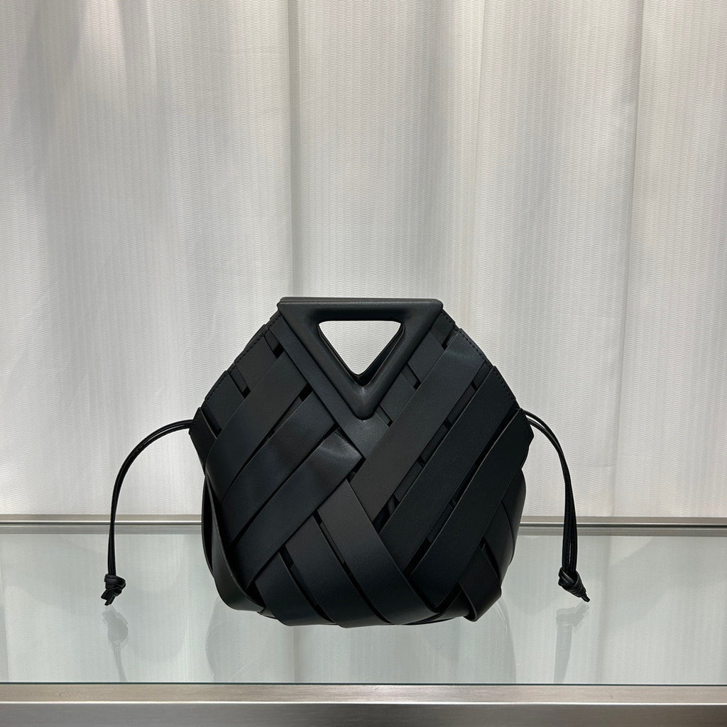 Black  leather bag with geometric design on a reflective surface