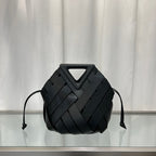 Black  leather bag with geometric design on a reflective surface