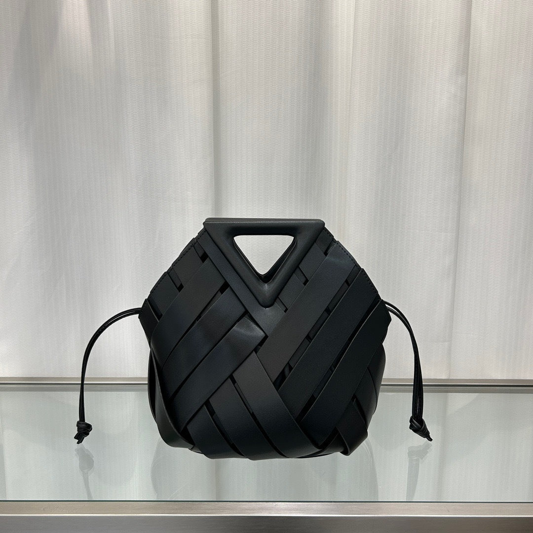 Black  leather bag with geometric design on a reflective surface