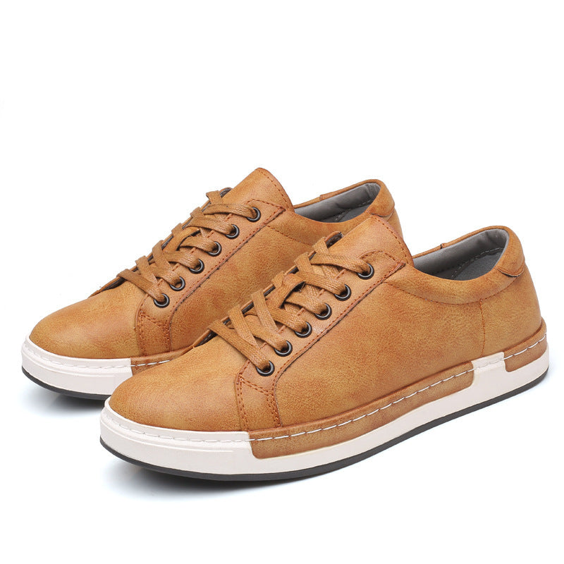 Pair of brown sneakers with white soles on a white background