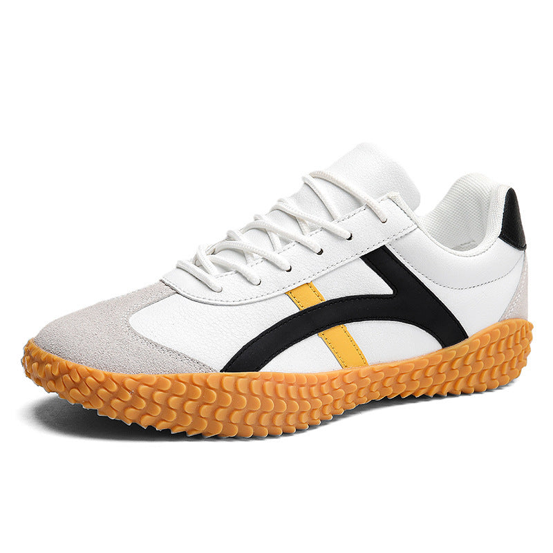White sneaker with black and orange accents on a white background