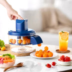 Fruit peeler with oranges, a glass of juice, and fruits on a table.