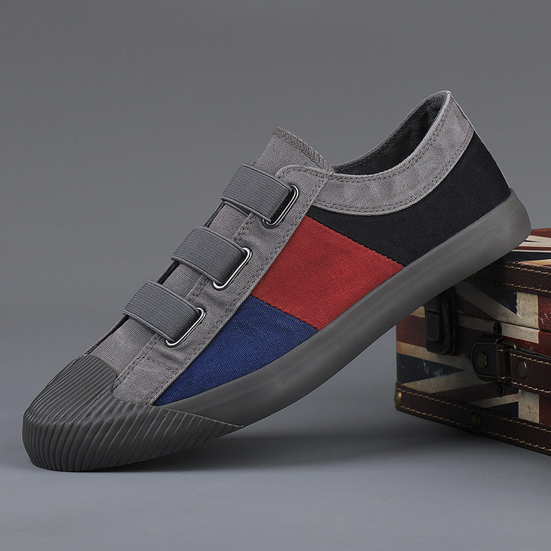 Multicolored sneaker with gray, red, and blue design on a gray background