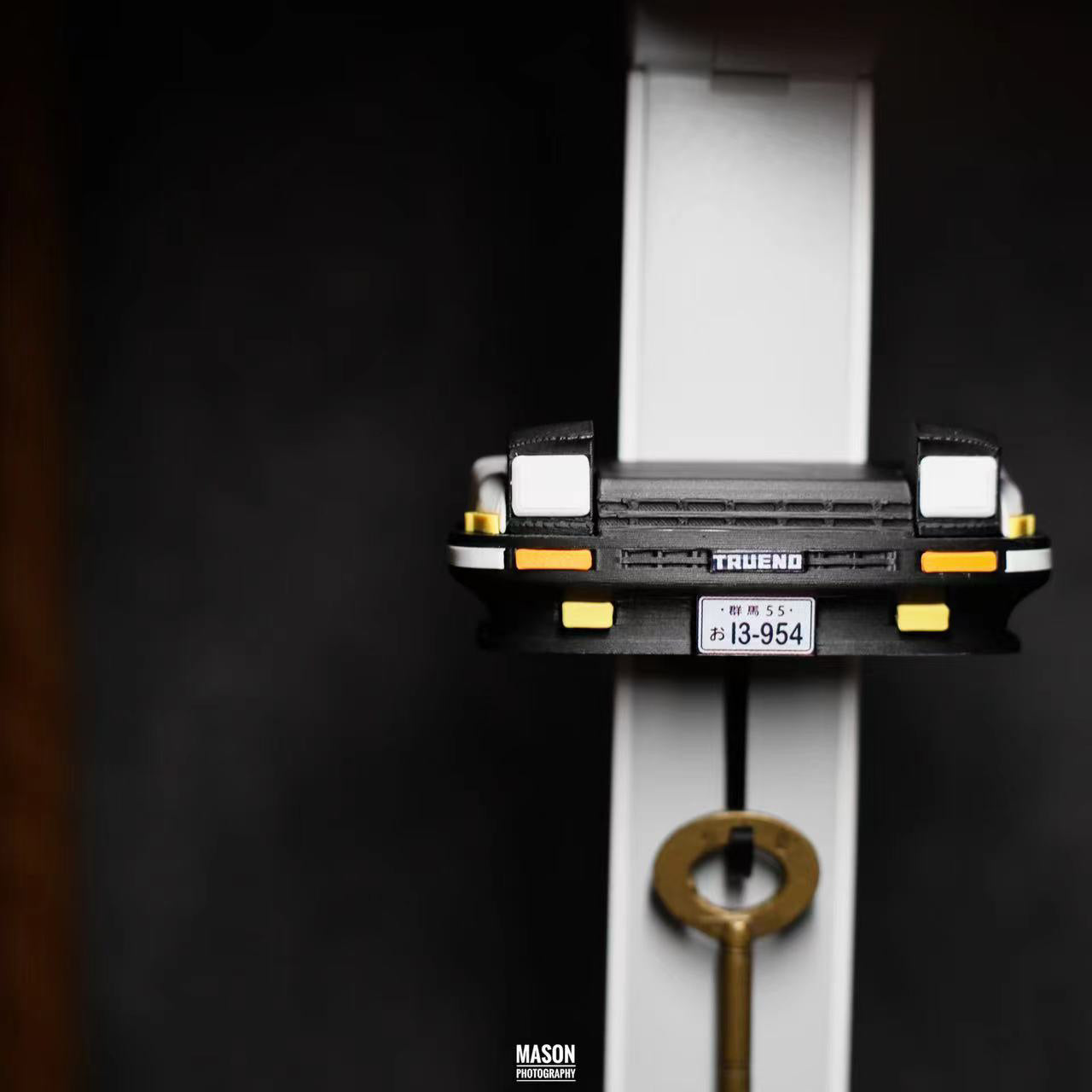 Model of a truck with a license plate and key on a dark background