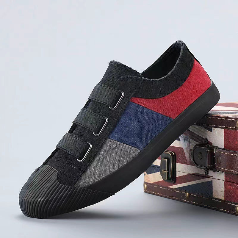 Multicolored sneaker with black, red, and blue design on a light gray background.