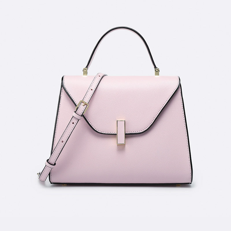 Pink handbag with a strap on a light gray background