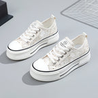 White sneakers with black accents on a light gray background