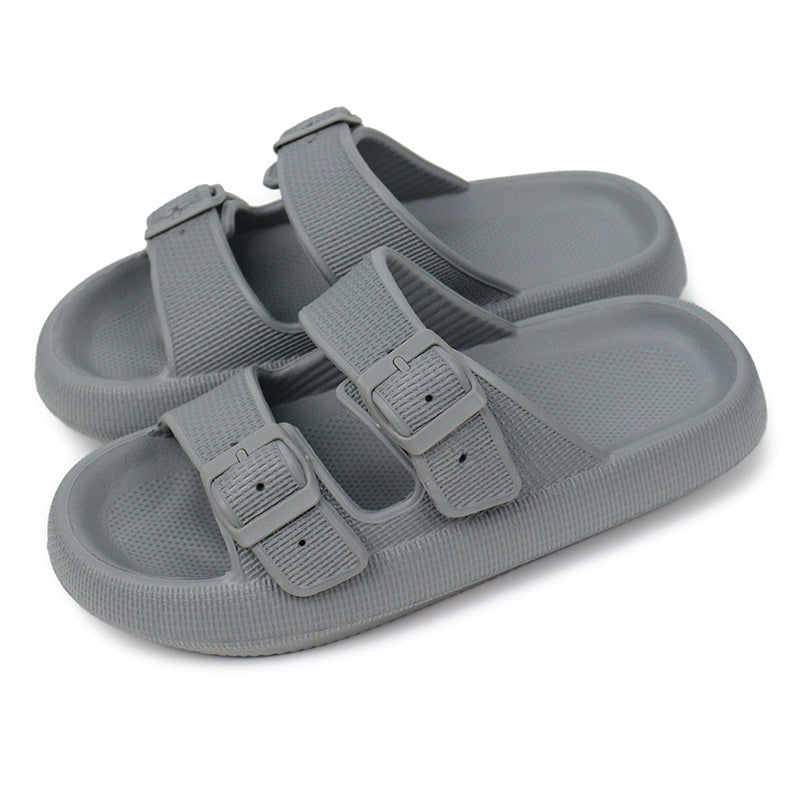 Gray sandals with buckle straps on a white background