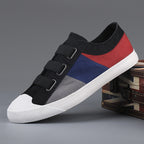 Multicolored sneaker with black, red, and blue design on a gray background
