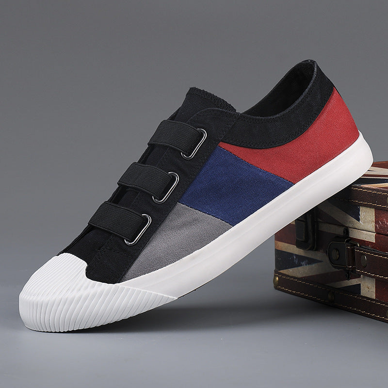 Multicolored sneaker with black, red, and blue design on a gray background