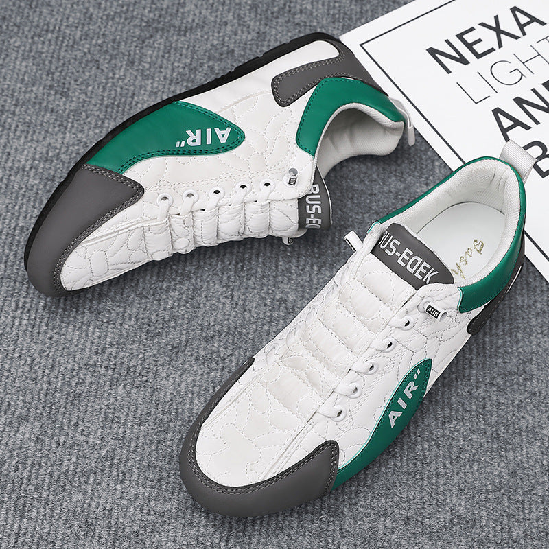 White sneakers with green and black accents on a gray surface