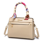 Beige handbag with a colorful handle on a white background