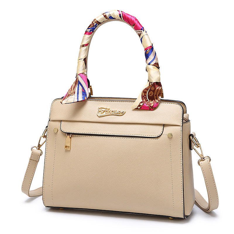 Beige handbag with a colorful handle on a white background