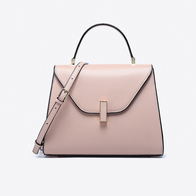 Pink handbag with a strap on a light gray background