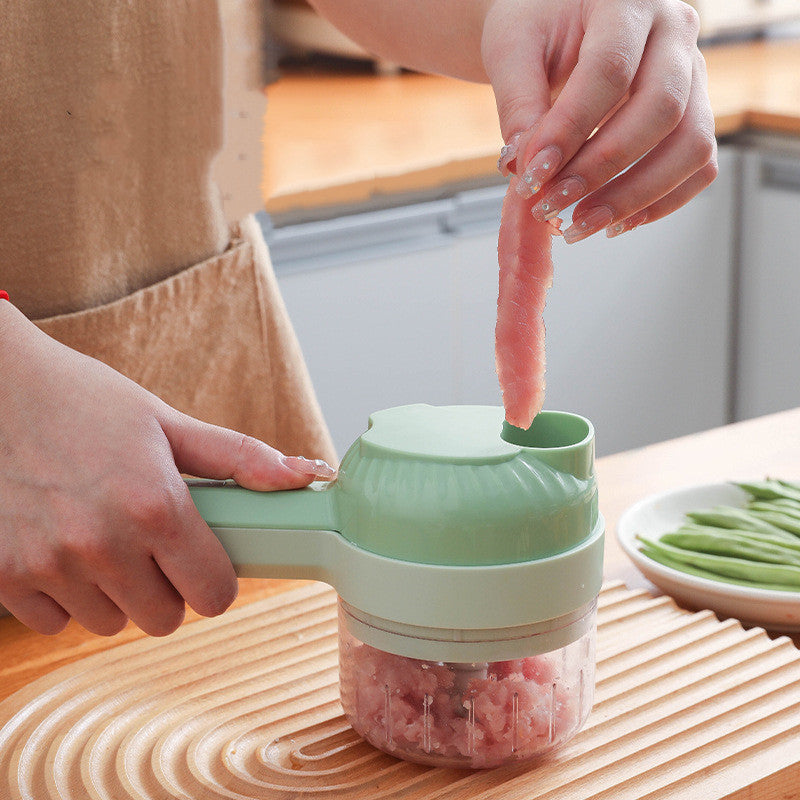 Person using a meat grinder on a wooden cutting board with a kitchen background.