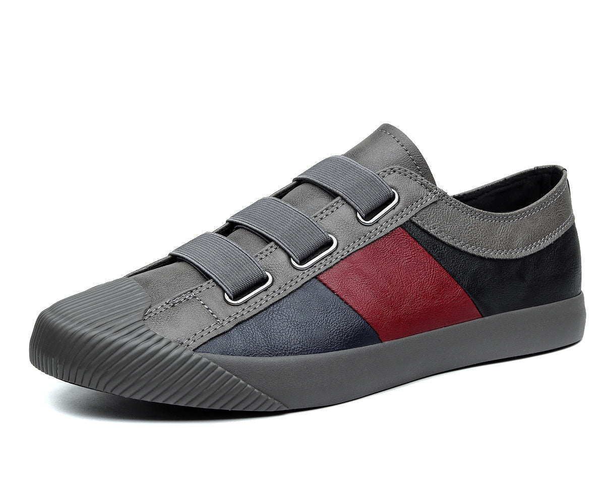 Gray and red sneaker with velcro straps on a white background
