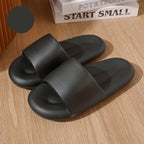Black slides on a wooden surface with a motivational book in the background.