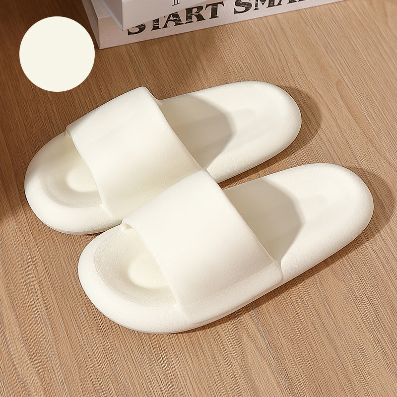 Pair of white slippers on a wooden surface