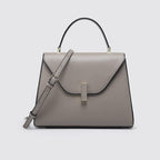Gray handbag with a strap on a light gray background