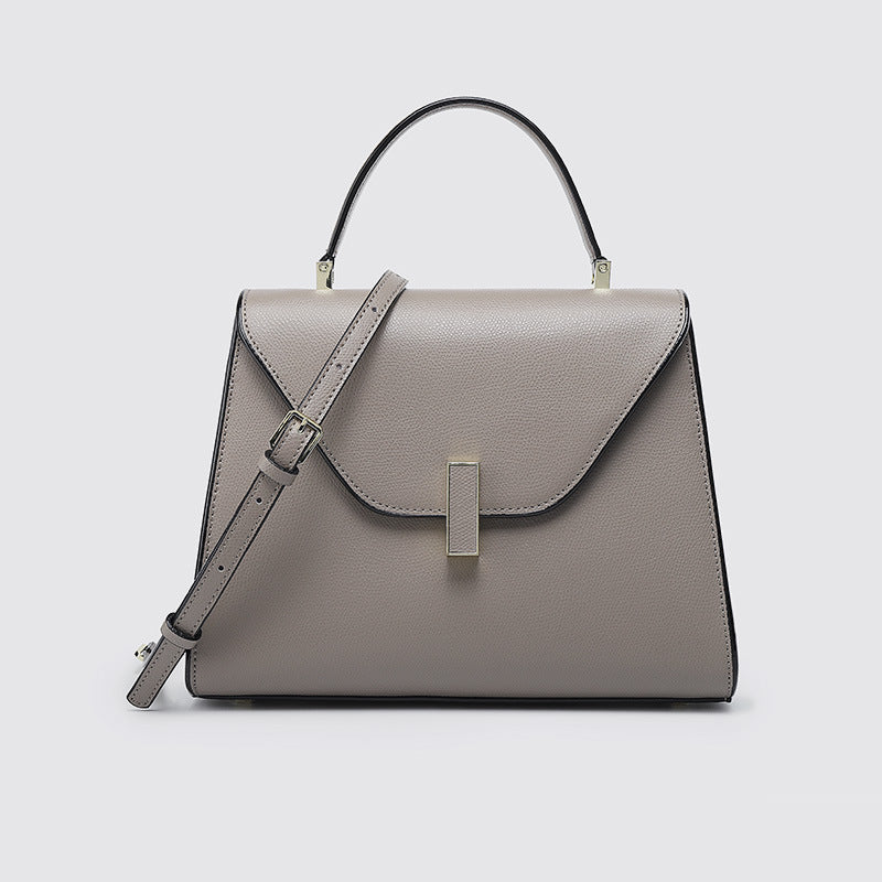 Gray handbag with a strap on a light gray background