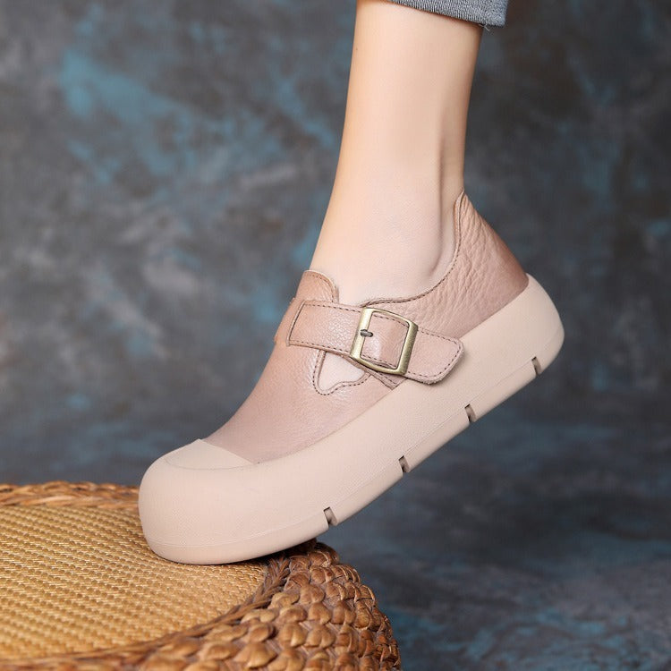 Beige shoe with a gold buckle on a blurred background