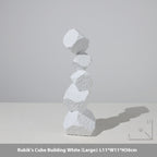 White Rubik's Cube Building sculpture on a light gray background