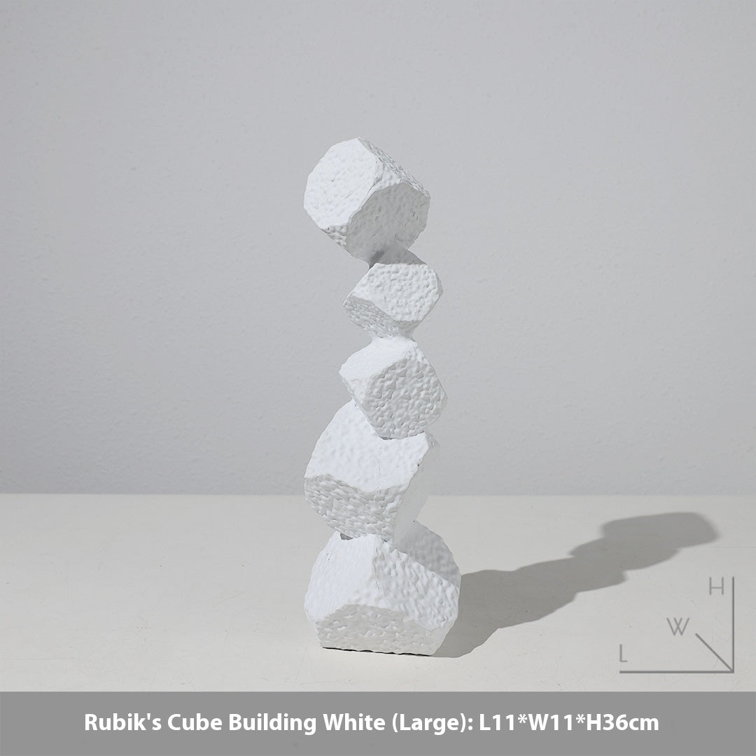 White Rubik's Cube Building sculpture on a light gray background