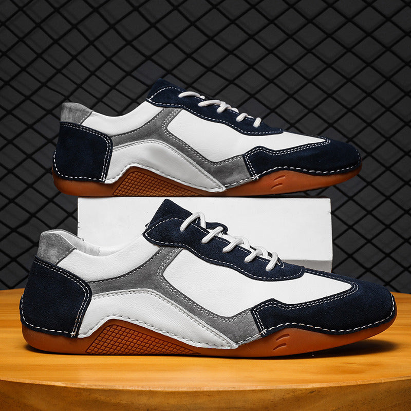 Pair of sneakers with white, blue, and brown color scheme on a wooden surface.