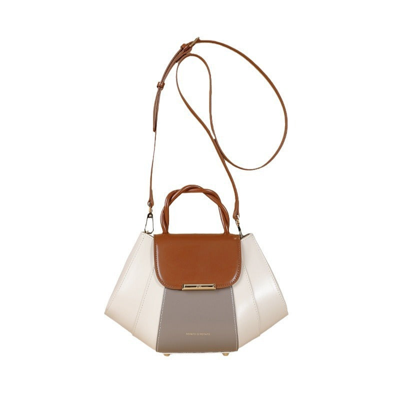 Multicolored handbag with brown, white, and gray sections on a white background
