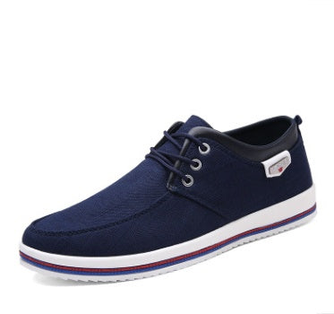 Navy blue casual shoe with white sole on a white background
