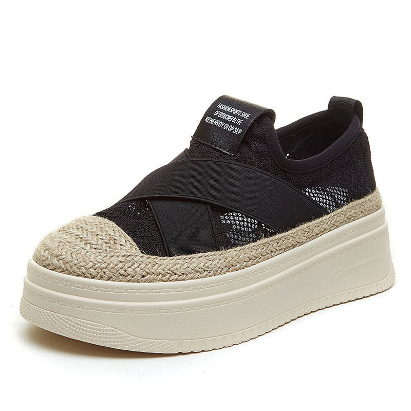 Black sneaker with a textured beige sole on a white background