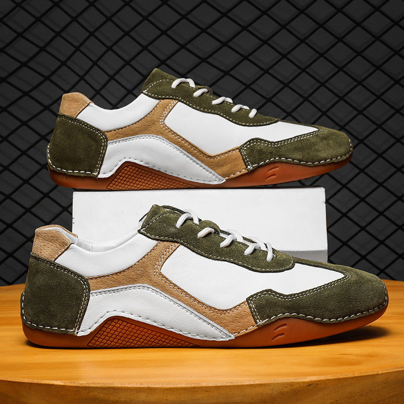Pair of green and brown sneakers on a wooden surface with a black grid background